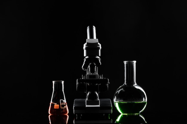 laboratory microscope on table in the dark