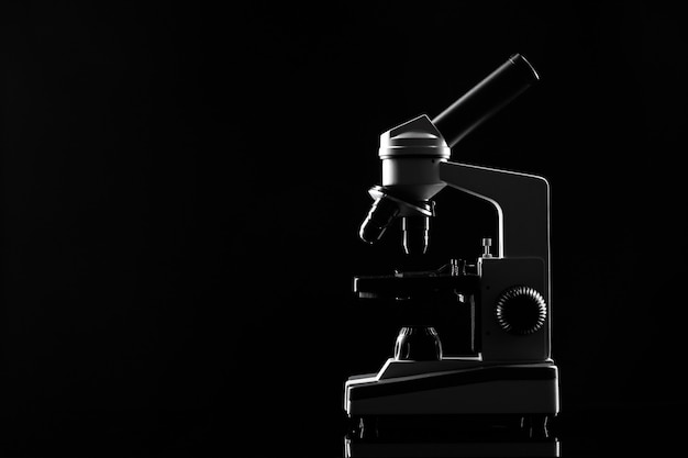 Laboratory microscope on table in the dark