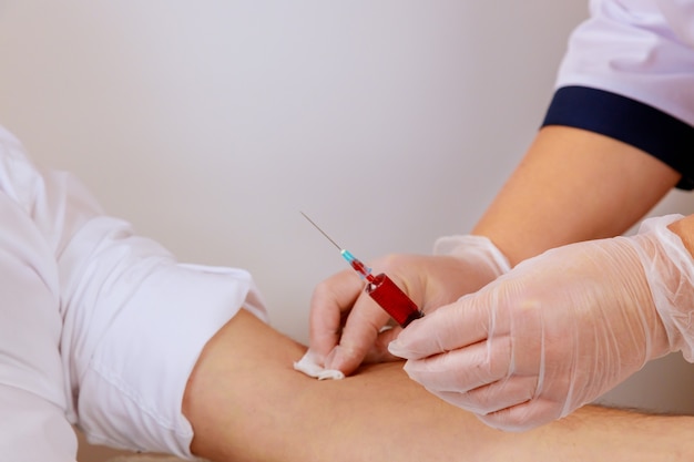 Laboratory nurse takes blood sample from arm on the analysis for dna