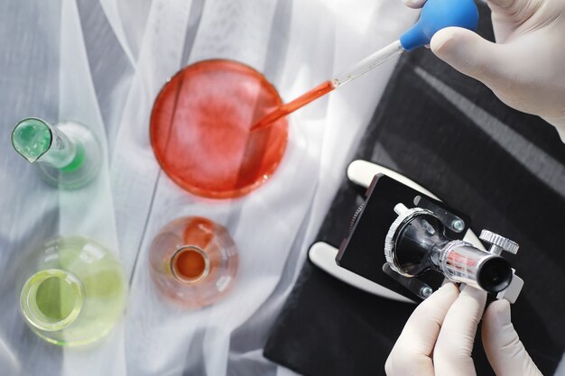 Laboratory research. Drug testing. Chemical experiments in the laboratory. Microscope various test tubes and beakers on the table at the medical officer.