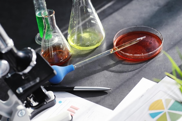 Laboratory research. Drug testing. Chemical experiments in the laboratory. Microscope various test tubes and beakers on the table at the medical officer.