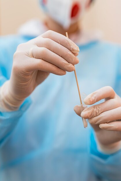 Laboratory specialist close up view hands Professional scientist holds a test tube