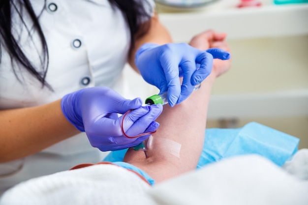 Laboratory with nurse taking a blood sample from patient