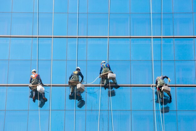 Laborers clean windows as a team on a skyscraper in downtown seoul south korea