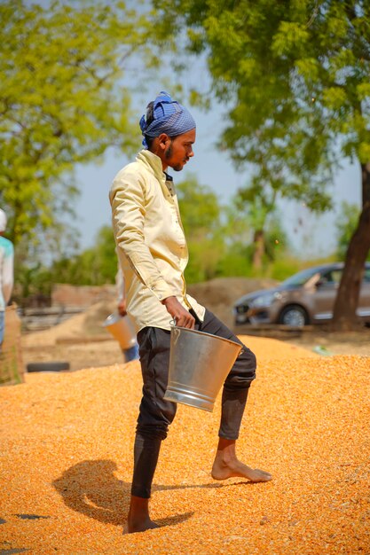 laborers packing jute bags of corn