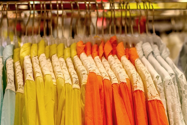 Lace shirts hanging on hangers in shop