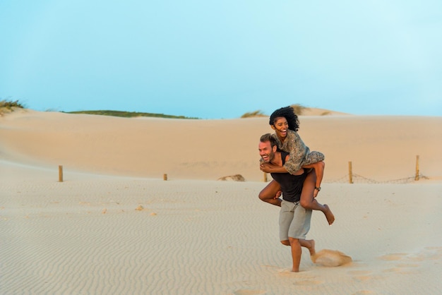 Lachen om meeliften met plezier op het strand