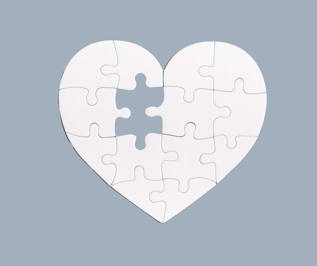 Photo lacking missing puzzle piece element in heart jigsaw