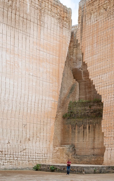 Photo ladder to the bottom of a deep impressive sandstone quarry