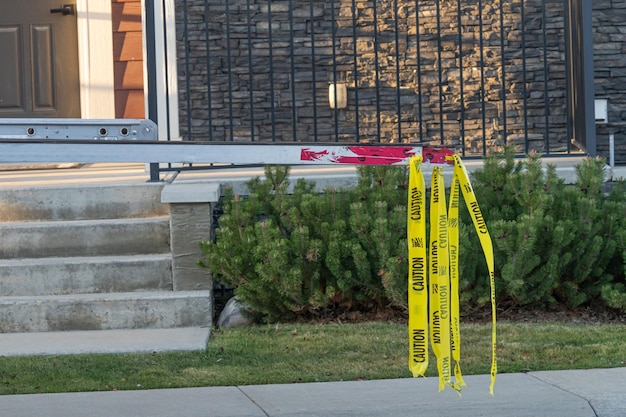 Ladder hanging out of truck with yellow caution tape