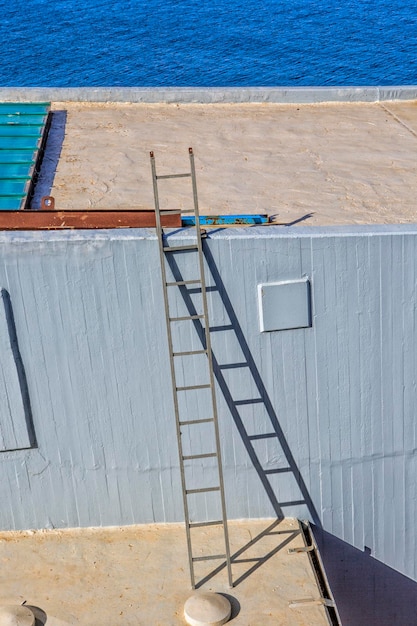 Ladder near the wall next to the sea