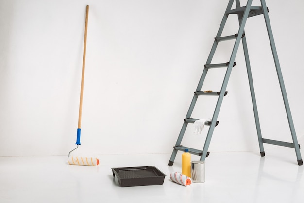 Ladder and painting tools. Repair in the room