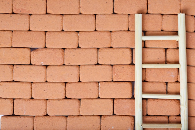 Ladder on a redbrick wall. Baackground.Closeup