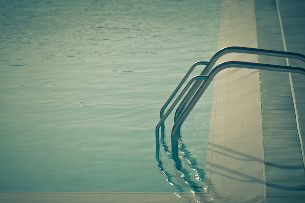 Ladder of a swimming pool. Horizontal vintage style shot