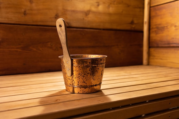 Ladle in the bath in a Russian wooden bath a metal bucket Selective focus