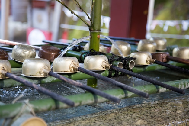 Ladles for hands cleaning at entrance to shirne of temple in Nikko, Japan