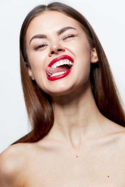 Lady bare shoulders grimace shows the tongue of a fun lifestyle skin care closeup