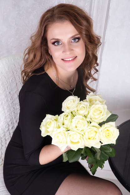 Lady in black dress and white roses