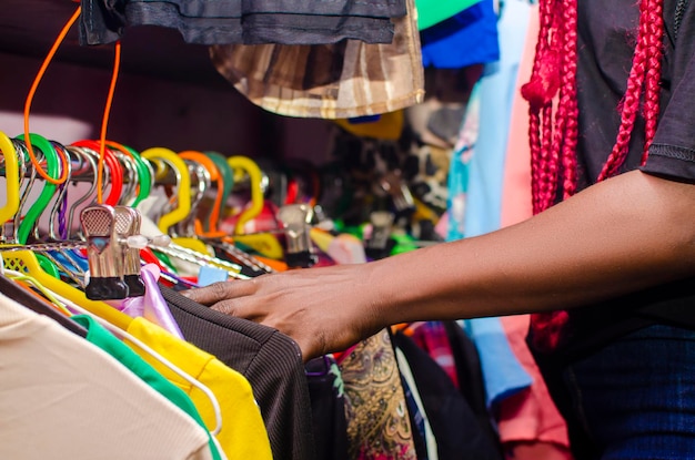 Lady checking Multi-coloured wardrobe showcase, closeup