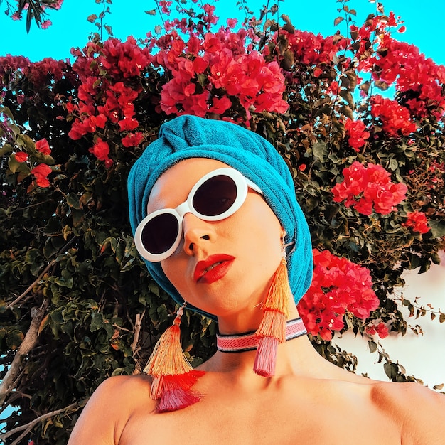 Lady in fashion beach accessories. Head scarf, sunglasses and earrings. Beach fashion outfit