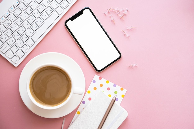 Lady freelancer's thuis pastelroze werkplek kopje koffie en smartphone mockup