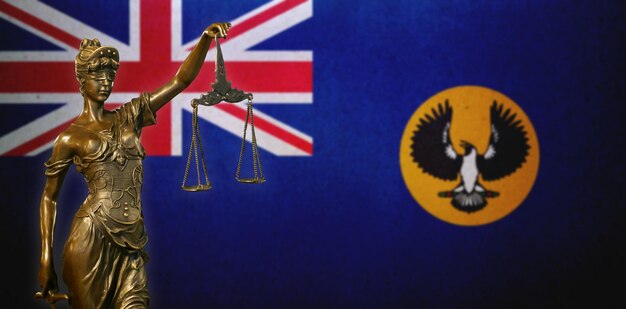 Lady Justice against a flag of South Australia