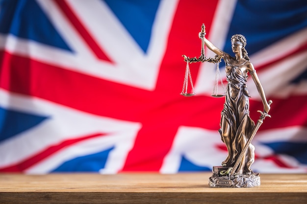 Lady Justice and United Kingdom flag. Symbol of law and justice with UK Flag. Brexit.