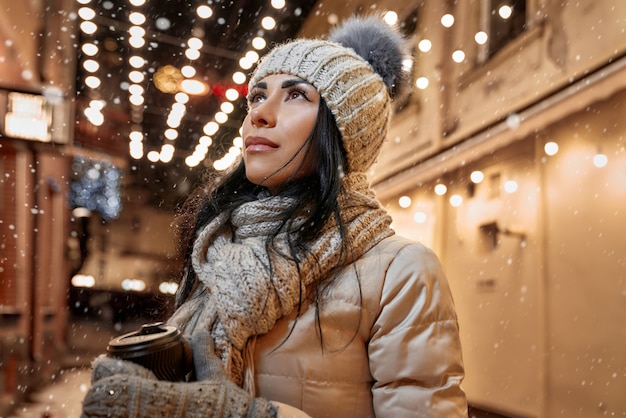 Lady in modern winter clothing on street.