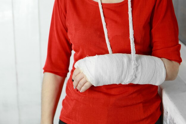 A lady in a red jacket with a broken arm