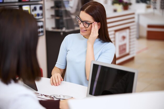 Lady slightly shifting the spectacles to one side