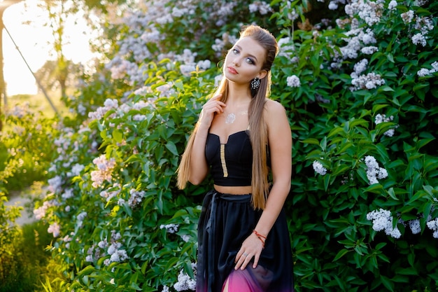 Lady in a summer dress on a near the bushes