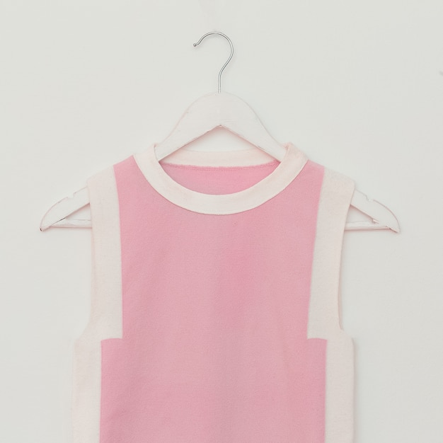 Lady T-shirt hanging on white background. Vanilla style