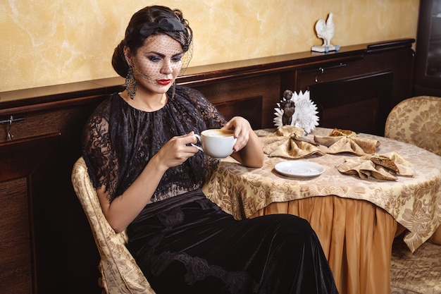 Lady with a cup of coffee.