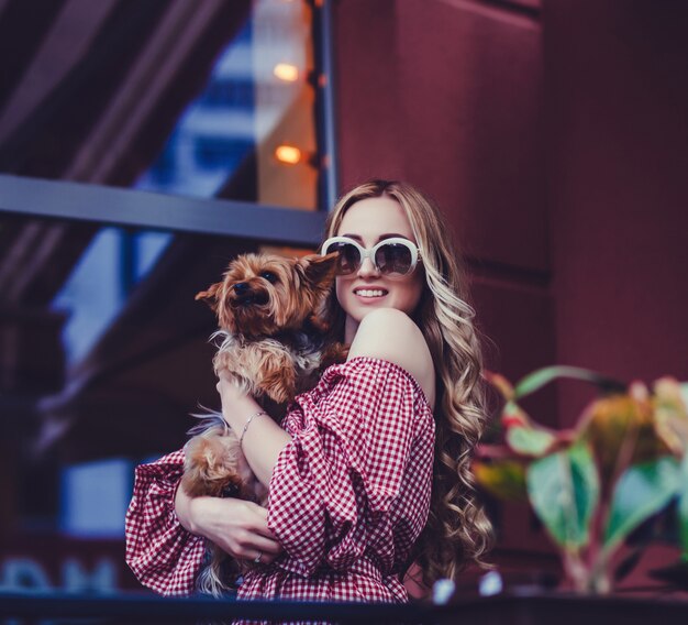  lady with dog posing in the city