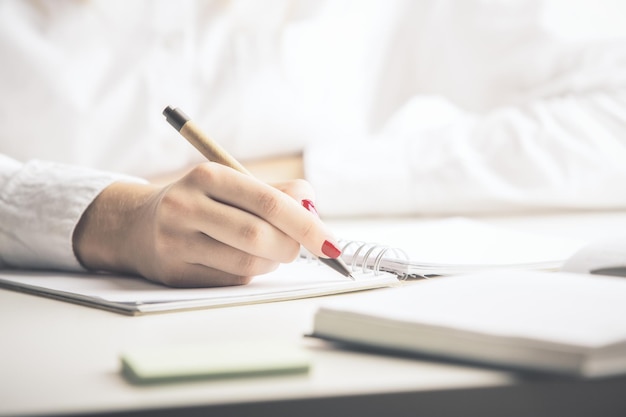 Lady writing in notepad