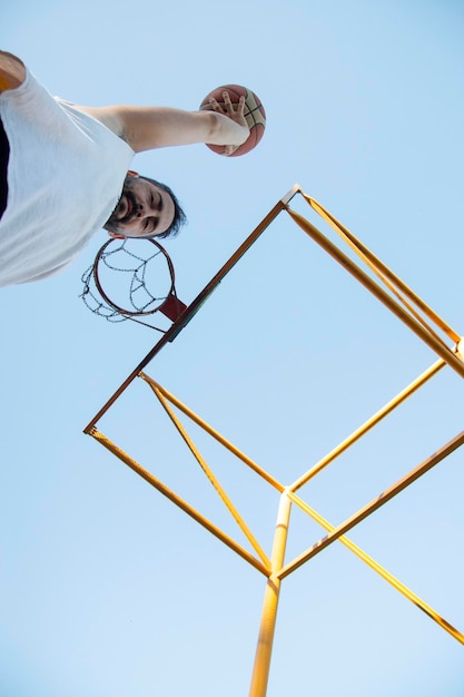 Foto lage hoek van een basketbalspeler die de bal vasthoudt