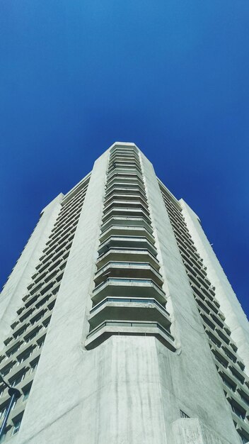 Foto lage hoek van een modern gebouw tegen een heldere blauwe hemel