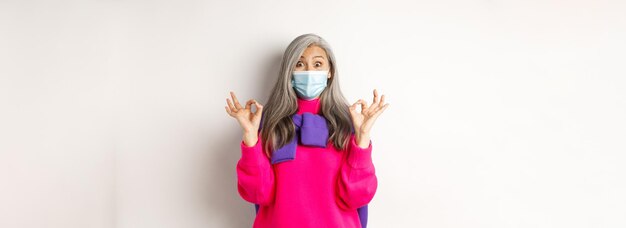 Lage hoek van een vrouw met een hoed op een witte achtergrond