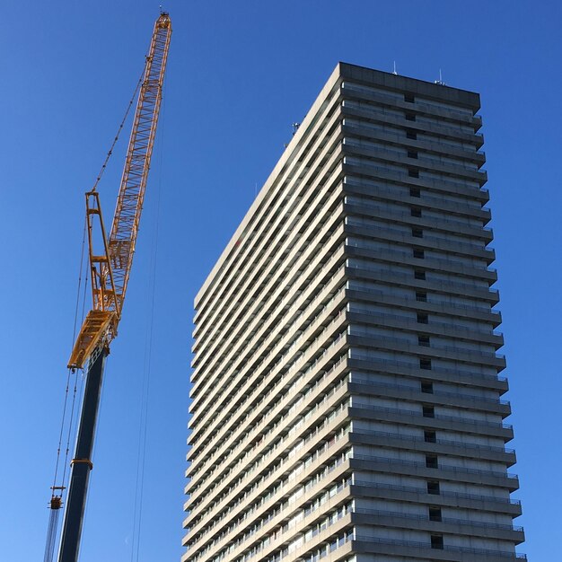 Foto lage hoek van het gebouw tegen een heldere blauwe lucht