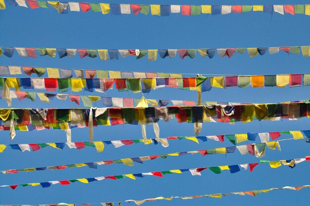 Foto lage hoek van veelkleurige vlaggen tegen een blauwe hemel