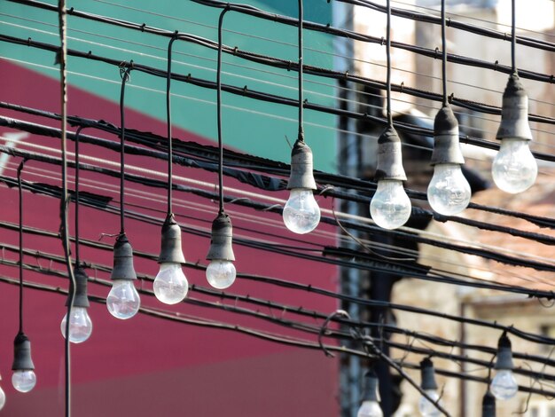 Foto lage hoek van verlichte gloeilampen die aan het plafond hangen