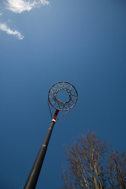 Foto lage hoekmening van basketbalring tegen de hemel