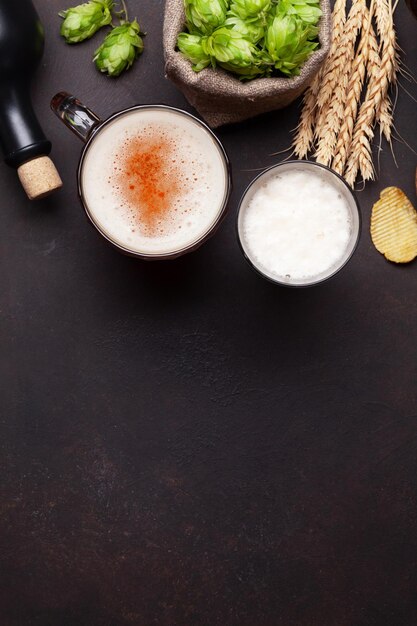 Lager beer mug hops and wheat on old stone table