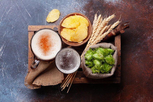 Lager beer mug hops and wheat on stone table