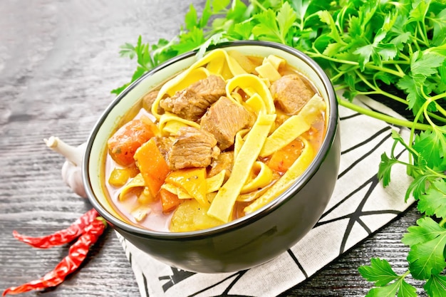 Lagman in bowl on black wooden board