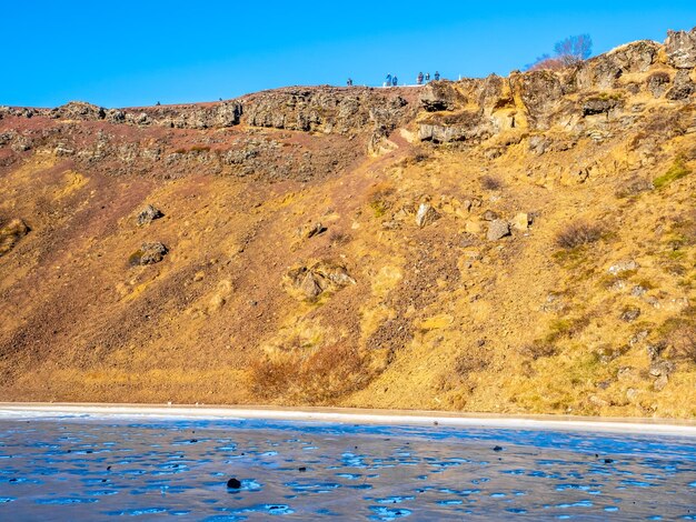 Lake becomes ice in winter season at kerid crater iceland