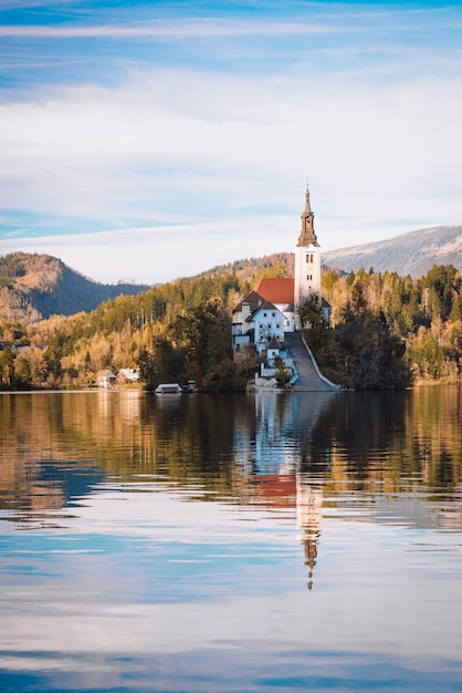 Lake Bled in the Alpine mountains in autumn under blue sky