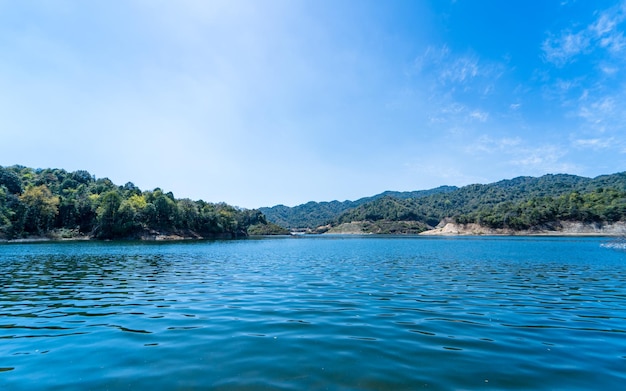 The lake is surrounded by mountains and the sky is blue