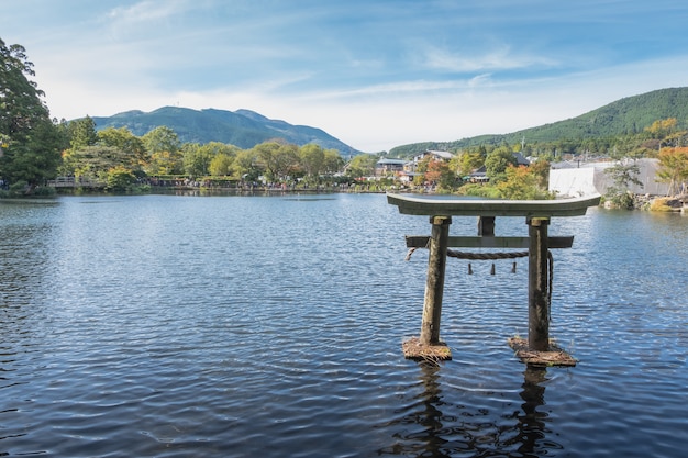 Lake Kinrin en Japanse poort (Torii) met Mount Yufu en blauwe hemelachtergrond bij Yufuin, Oita, Kyushu, Japan