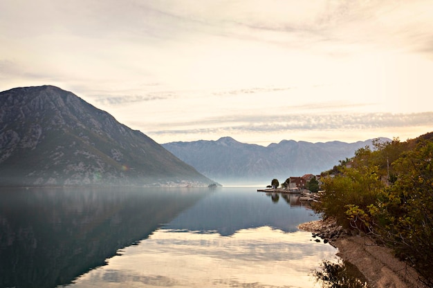 A lake in the mountains with a mountain in the background